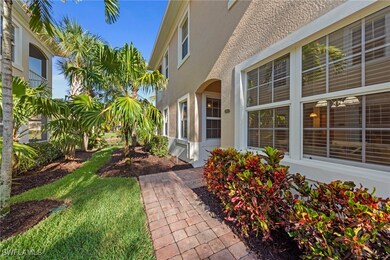 Property entrance with stucco siding and a yard