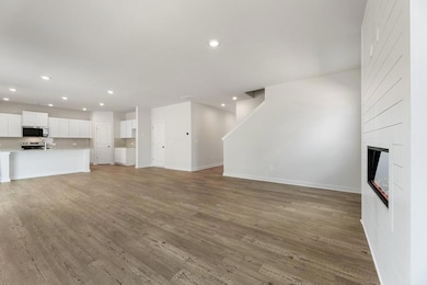 Unfurnished living room with recessed lighting, baseboards, light wood-style floors, and a fireplace