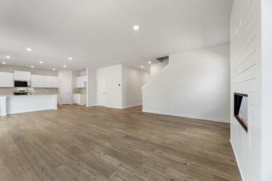Unfurnished living room with recessed lighting, baseboards, light wood-style floors, and a fireplace