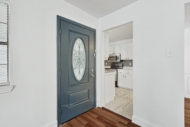 Entrance foyer with light hardwood / wood-style fl