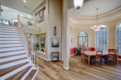 This dining room is bathed in natural
light streaming through expansive
windows.
