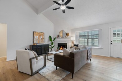 Living room featuring ceiling fan, beam ceiling, l