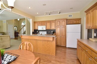 Custom kitchen with lovely hardwoods, pantry, isla