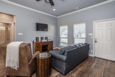 Living room with ornamental molding, ceiling fan, 