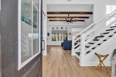 Entryway with stairway, light wood-style floors, c