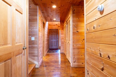 INT. HALLWAY TO FRONT ENTRANCE