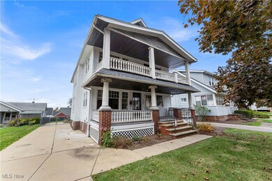 View of front of property featuring a porch, a front yard, and driveway