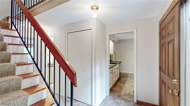 View from attached garage entryway*hallway with coat closet*Pocket door into kitchen*stairway to 2nd level