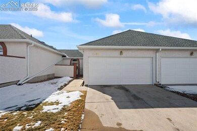 View of front of townhome featuring an enclosed pa