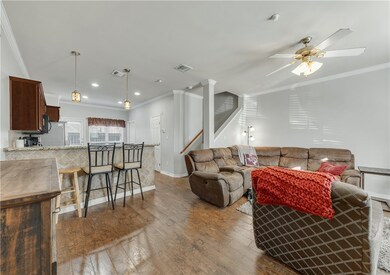 Living room with wood-type flooring, ceiling fan,