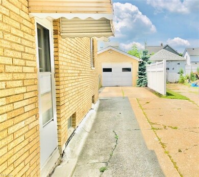 VIEW FROM THE PAVED DRIVEWAY LEADING TO THE GARAGE