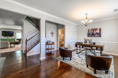 Foyer opens into a spacious office with upgraded 5-inch hand-scraped, pre-finished wood flooring and 9-foot ceiling, chair rail, and crown molding