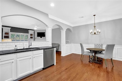 Kitchen featuring decorative columns, dark counter