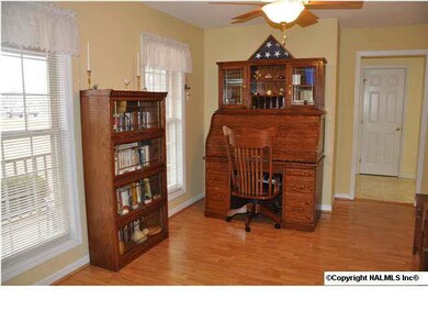 DINING ROOM OR STUDY WITH WOOD LAMINATE FLOORING IS LOCATED BETWEEN THE FOYER AND THE KITCHEN.