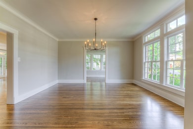 The large dining room is sure to impress. It opens to the den and kitchen area and foyer.