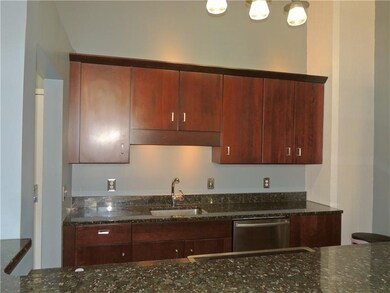 The updated kitchen with granite countertops and n