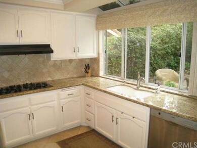 A wall of windows, granite counters, stone backspl