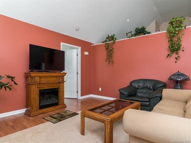 Great room and kitchen are separated by a plant sh