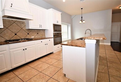 Kitchen with island breakfast bar.