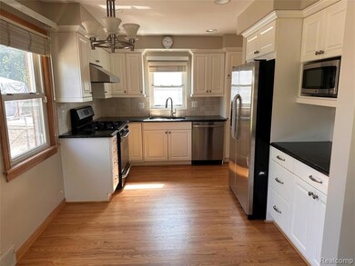 Kitchen featuring hanging light fixtures, appliances with stainless steel finishes, backsplash, dark stone counters, and recessed lighting