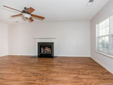 Great room with fireplace and large windows for na