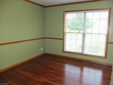 Formal dining room with hardwood floor.