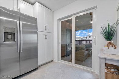 Kitchen with white cabinets, light tile patterned