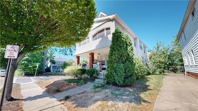 View of property hidden behind natural elements featuring covered porch