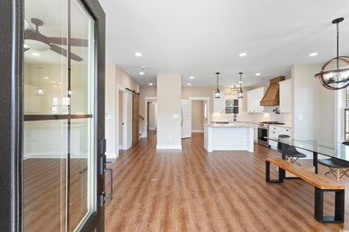Kitchen featuring a barn door, light wood-style fl