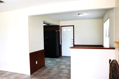 Kitchen with black refrigerator with ice dispenser