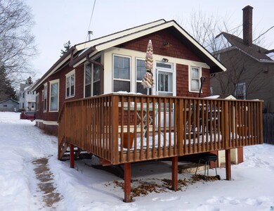 Snow covered house featuring a deck