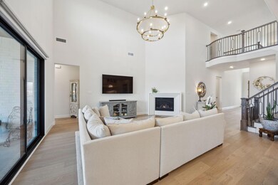 Living room featuring a lit fireplace, visible ven