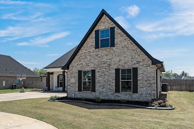 View of front facade with a front yard, fence, and
