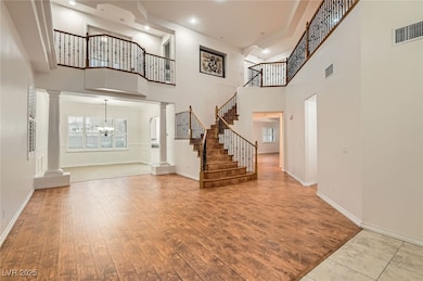 Entrance foyer with visible vents, ornate columns,