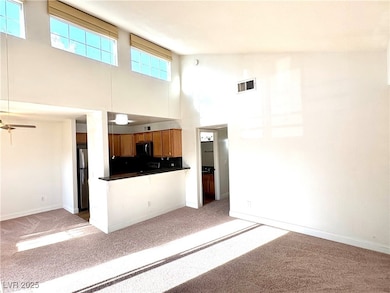 Unfurnished living room featuring a towering ceili