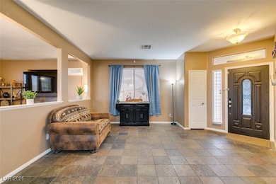 Foyer featuring baseboards and stone finish floors