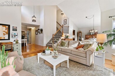 Living area featuring a chandelier, high vaulted c