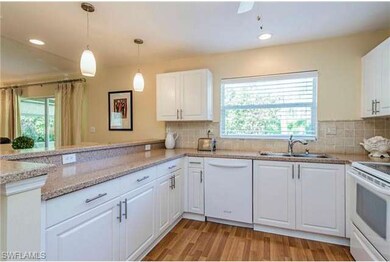 Bright white kitchen with plenty of work space to prepare meals.