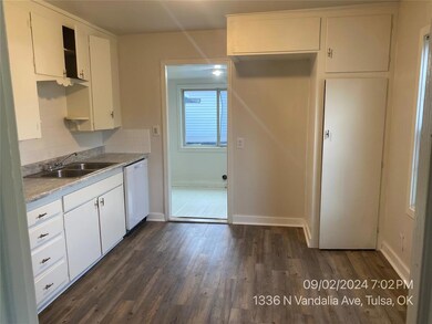Kitchen featuring white cabinets, backsplash, dish