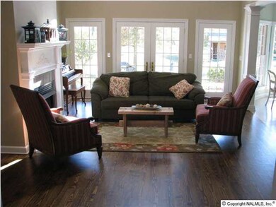 The living room with vaulted ceiling, newly refinished pine floors and gas log fireplace is open to the kitchen and breakfast area. The downstairs has all been freshly painted.
