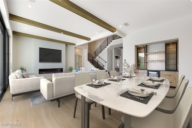 Dining area with beamed ceiling, visible vents, re