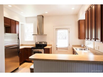 The renovated Kitchen boasts ceramic tile floors, stainless steel appliances, and a breakfast bar overhang perfect for casual dining.