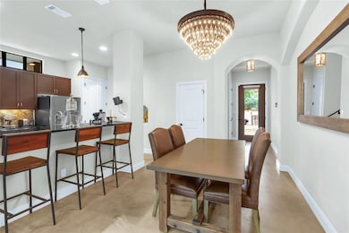 Dining room featuring concrete flooring, arched w