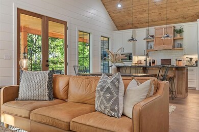 Living room with vaulted ceiling, light wood finished floors, recessed lighting, wood ceiling, and wood walls