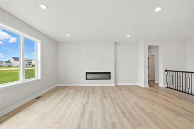 Create picture perfect memories while you gather in your spacious living room.  Add an extra glow to the ambience with your modern electric fireplace.  Picture of actual home.