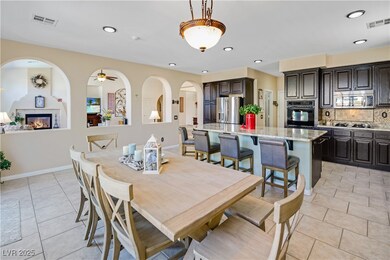 Dining area with a tile fireplace, visible vents,