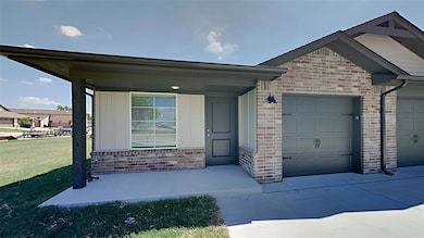 Craftsman-style house featuring brick siding, a garage, concrete driveway, and board and batten siding