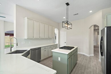 The kitchen has been updated with new quartz counter tops, Cheveron patterened backsplash, white cabinets, new deep sink and light fixtures.