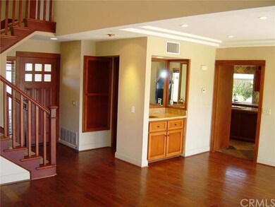 Wet bar in living room has custom copper sink with