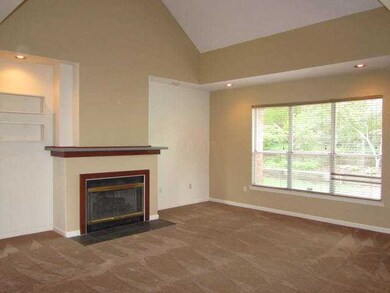 Roomy den with new carpet, fireplace and sunny win